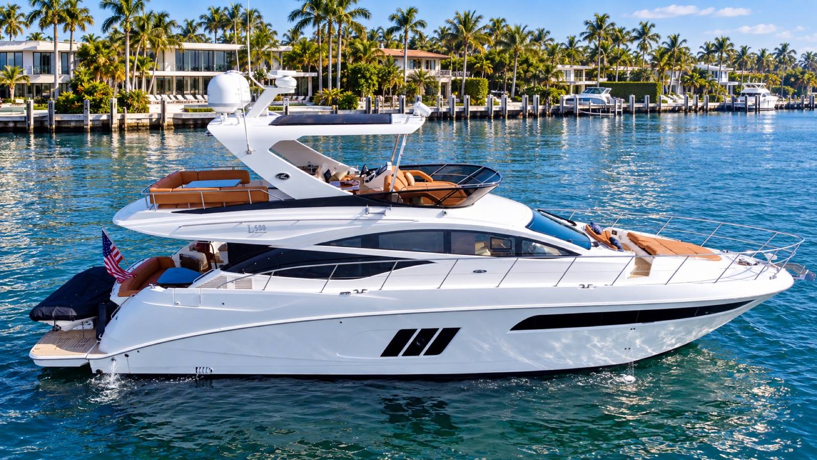 Sea Ray 64 flybridge yacht at anchor off waterfront homes in Miami