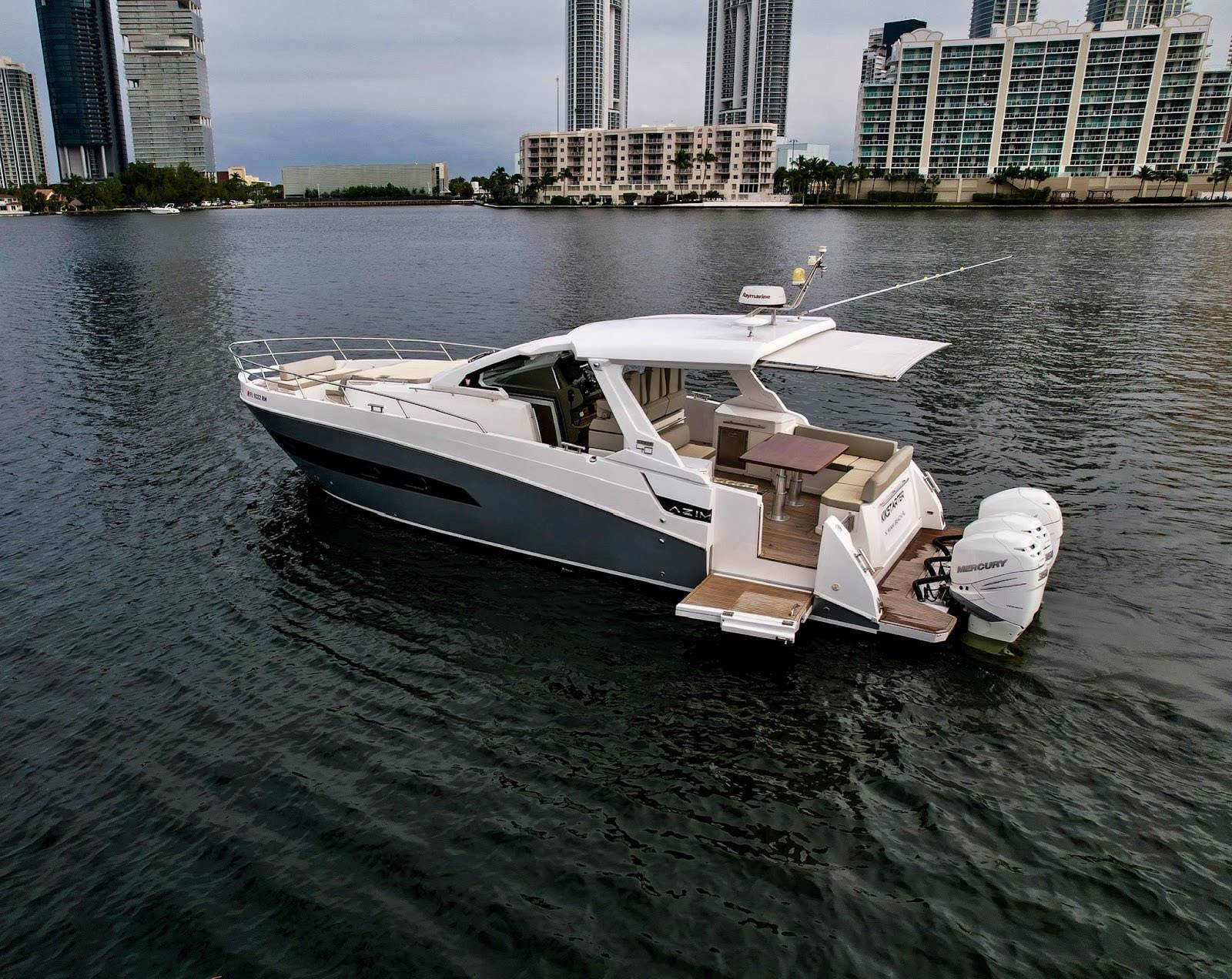 Azimut Verve 42 day boat at anchor below the Sunny Isles towers