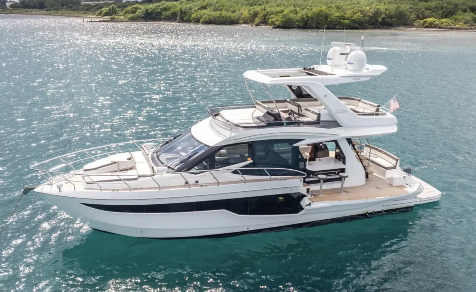 Galeon 53 at anchor over sparkling water, full side view