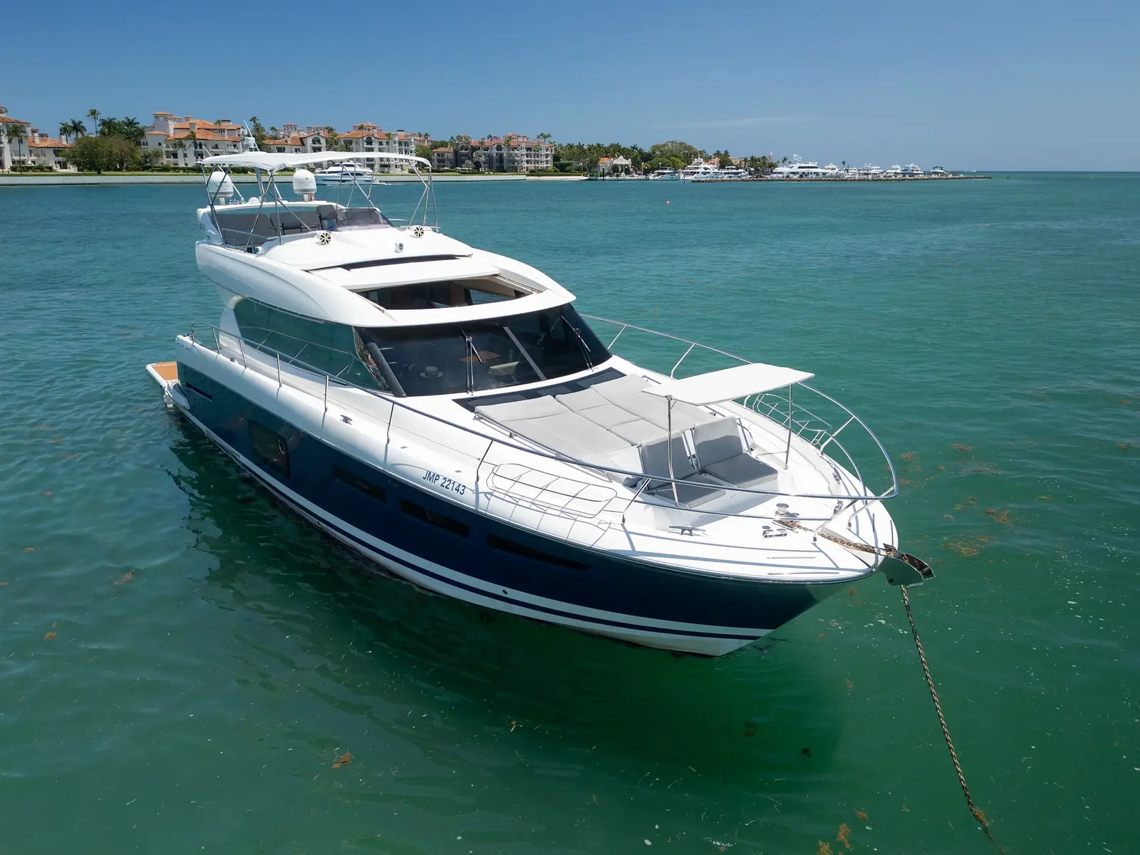 Prestige 65 "No Plans" at anchor over turquoise water