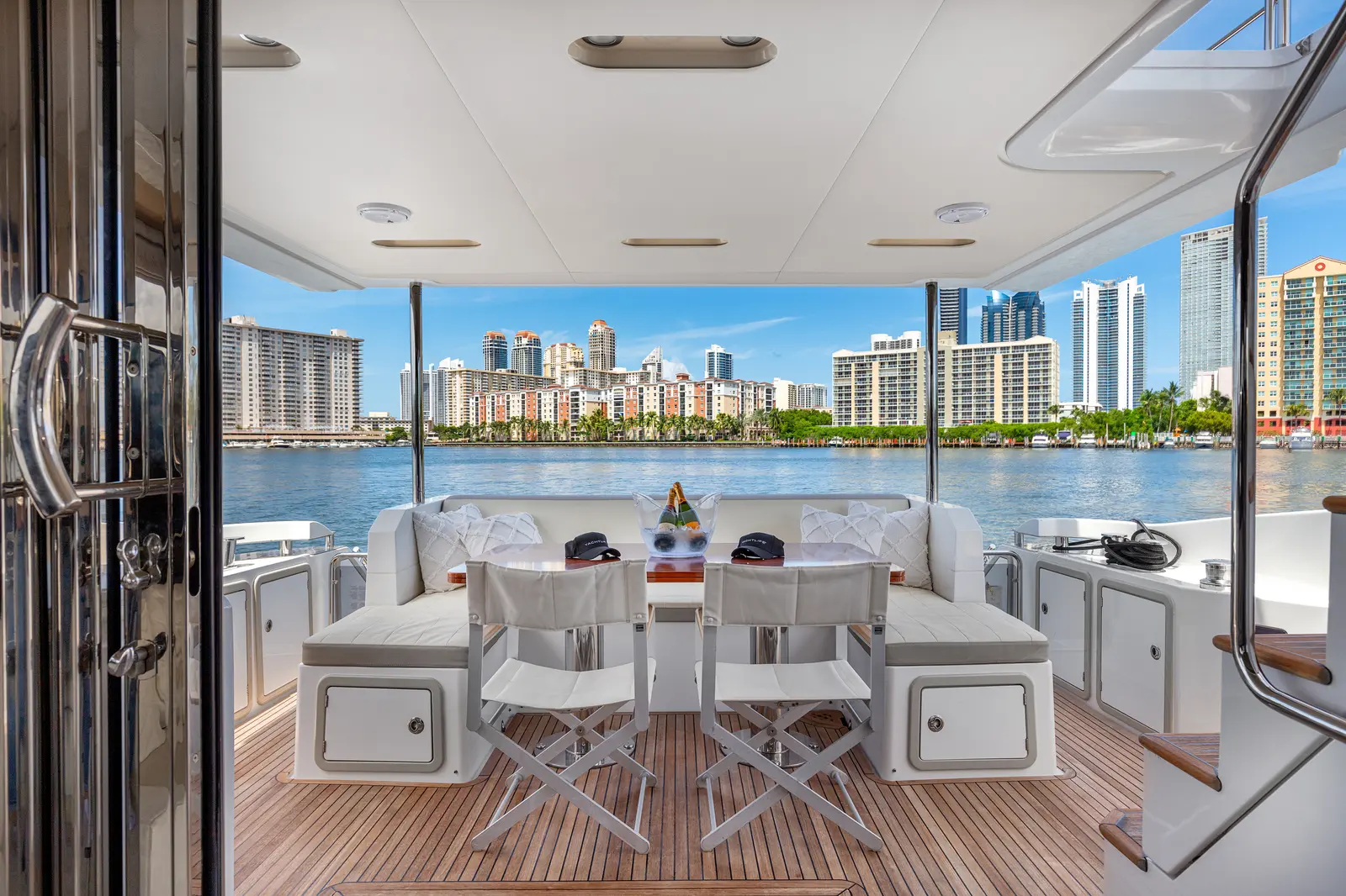 Azimut 68 "Le Grand Bleu" aft deck dining table with the city behind