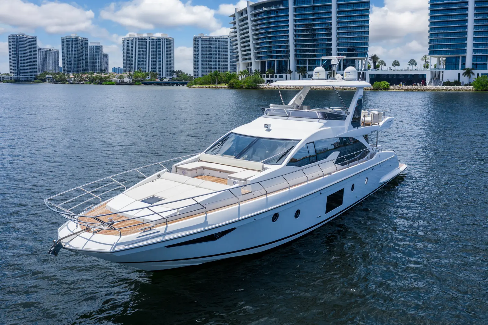 Azimut 68 "Le Grand Bleu" cruising past waterfront towers