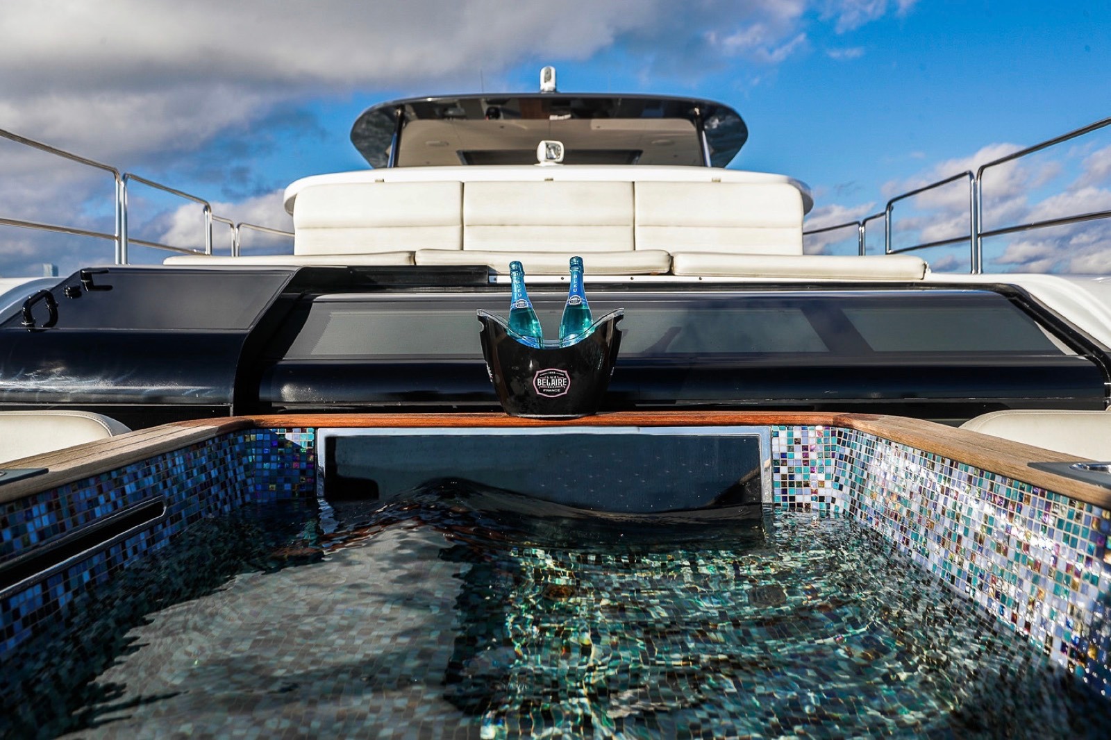Yacht top deck with a jacuzzi and champagne set out for a proposal in Miami