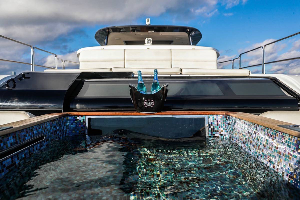 Yacht top deck with a jacuzzi and champagne set out for a celebration