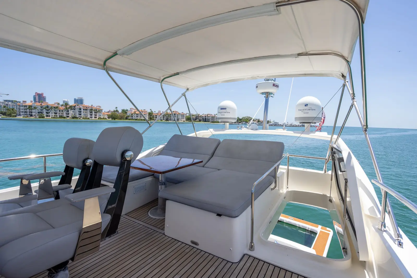 Prestige 65 "No Plans" flybridge lounge with the floating pool below