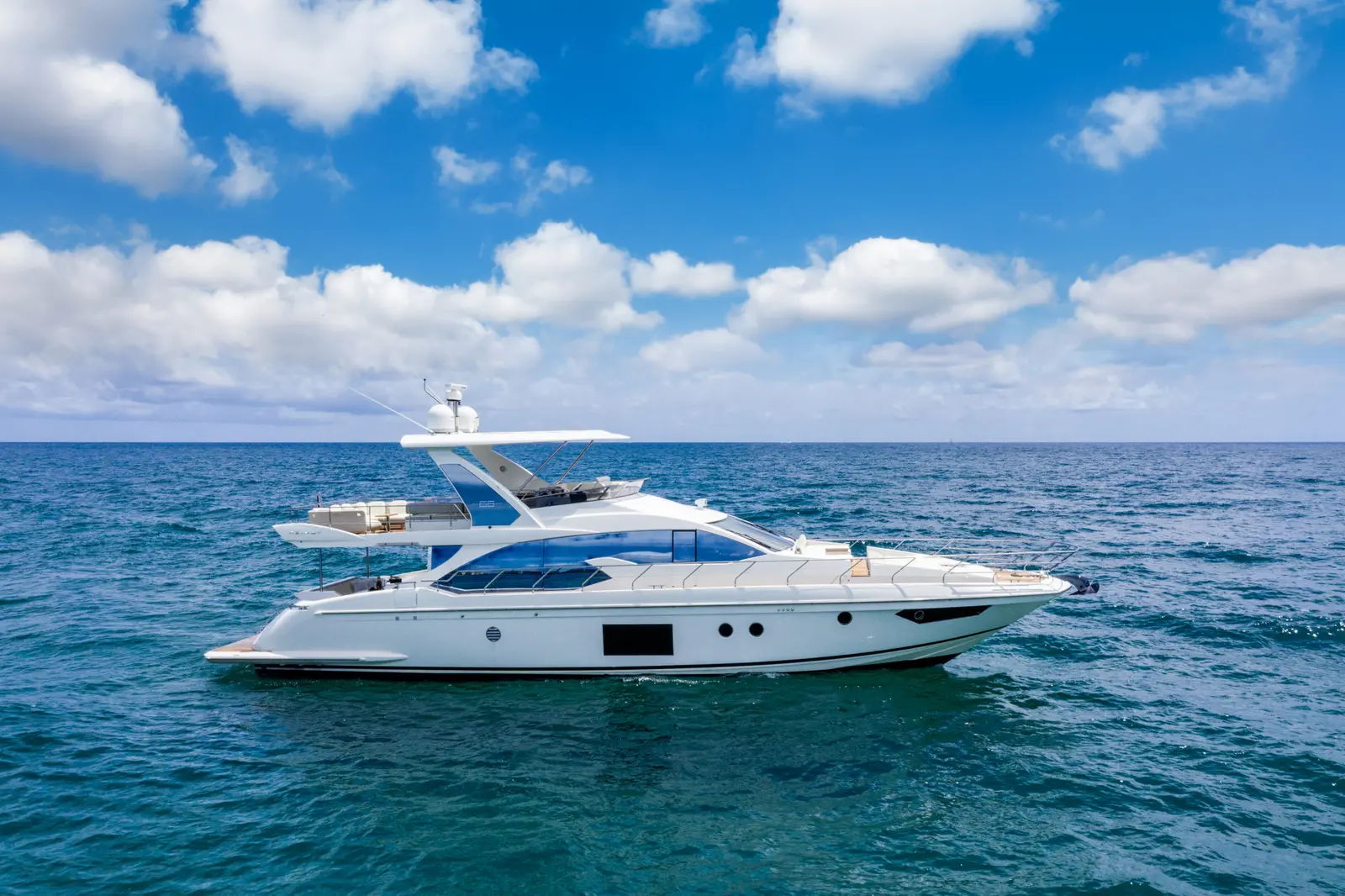 Azimut 68 "Le Grand Bleu" underway on open water, aerial view