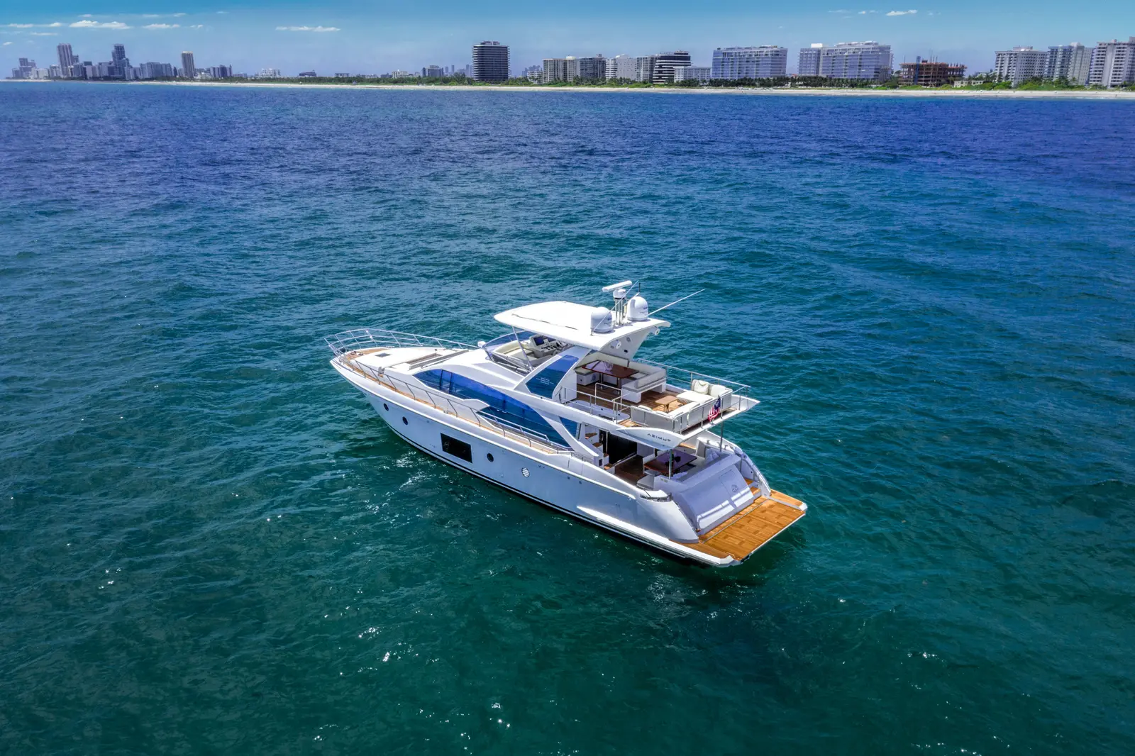 Azimut 68 "Le Grand Bleu" cruising on blue water from above