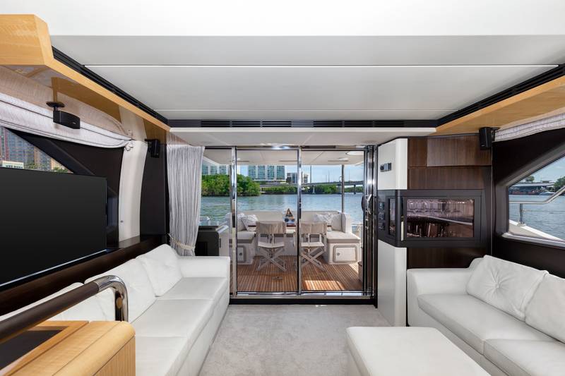 Azimut 68 "Le Grand Bleu" main salon with white sofas and TV