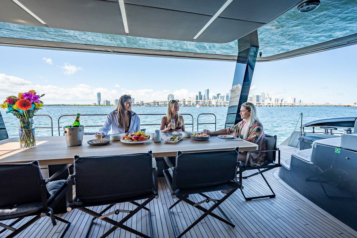 Lunch with flowers and champagne on the aft deck of the Sunreef 70, skyline behind