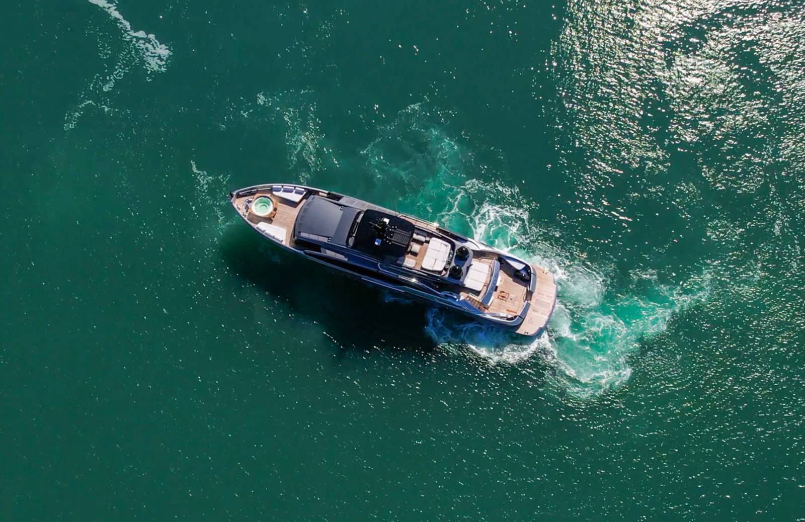 Aerial view of a Pershing GTX 116 superyacht cruising on turquoise water