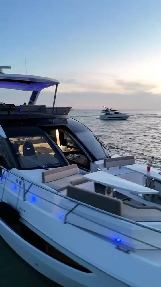 Yacht deck lit with blue lights at sunset on Biscayne Bay